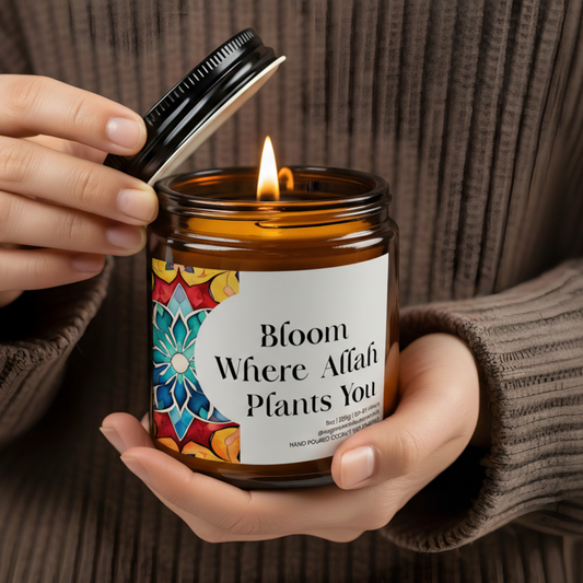 “Bloom Where Allah Plants You” Islamic soy candle in amber glass jar on a neutral décor tray