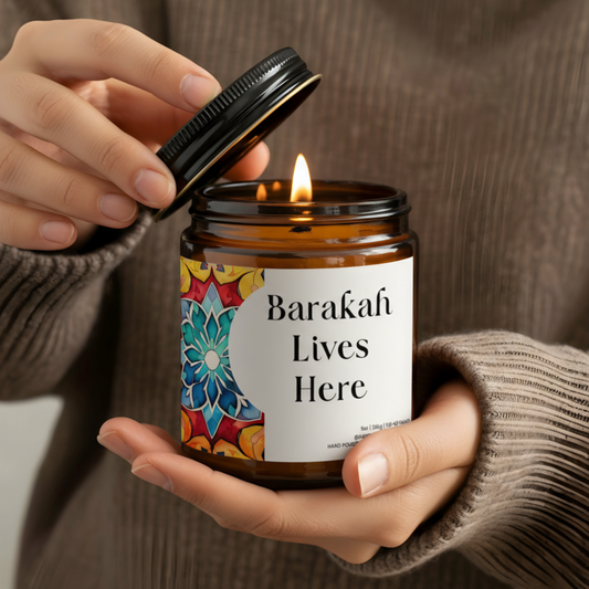 “Barakah Lives Here” Islamic soy candle in amber glass jar on neutral décor tray