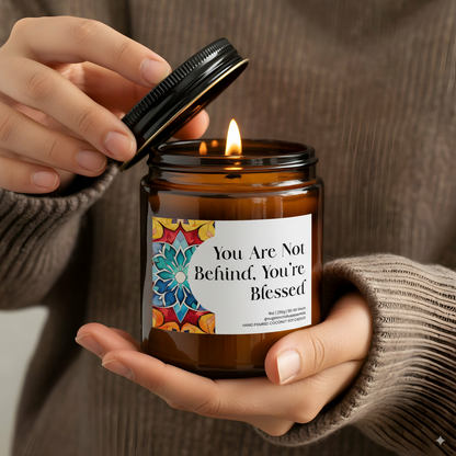 “You Are Not Behind, You’re Blessed” Islamic soy candle in amber glass jar on a neutral décor tray